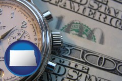 north-dakota map icon and hourly payroll symbols - a stopwatch and paper money